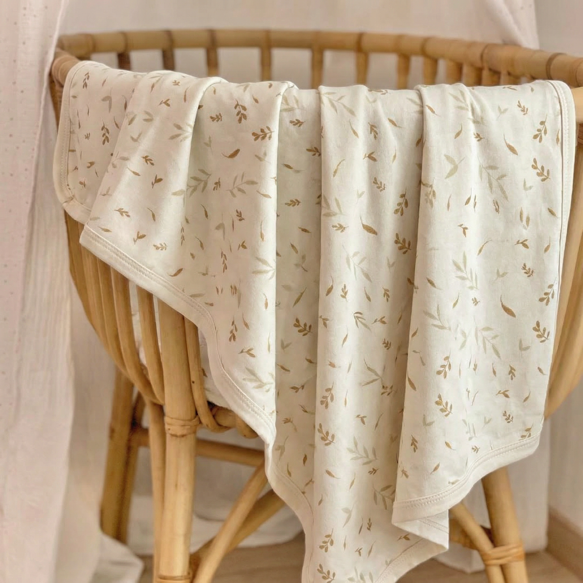 Beige patterned blanket draped over a wicker chair
