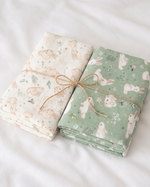 Two stacks of fabric with bunny patterns tied together on a white background