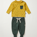 Yellow long-sleeve shirt with black pattern and green pants on a white background