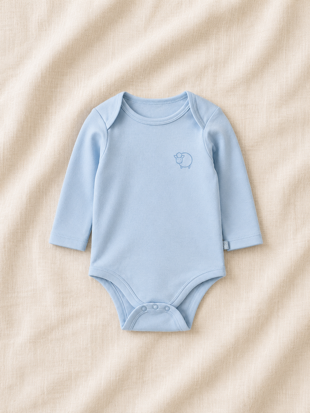Blue baby bodysuit with a logo on a beige fabric background