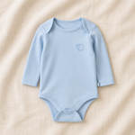 Blue baby bodysuit with a logo on a beige fabric background